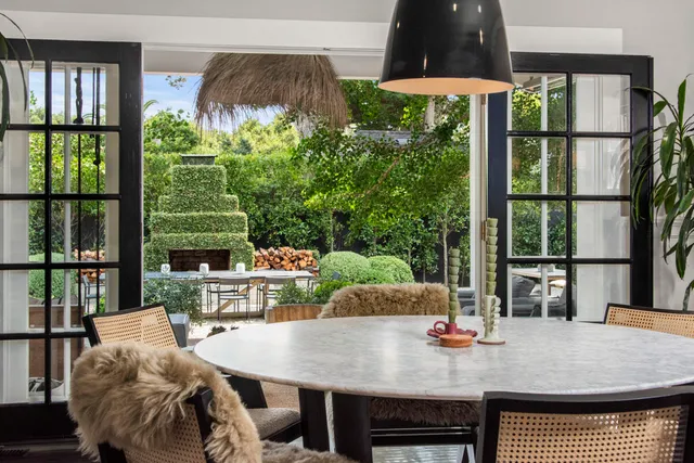 an outdoor sitting area with a tub and fire pit