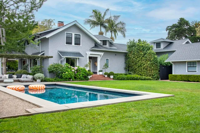 a bedroom with a bed chair and a large window