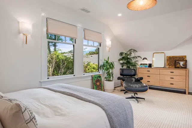 a living room with table chairs and wooden floor