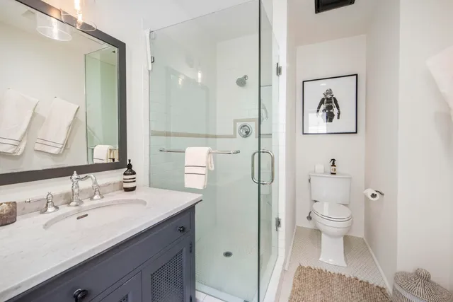 a bathroom with a sink toilet and shower