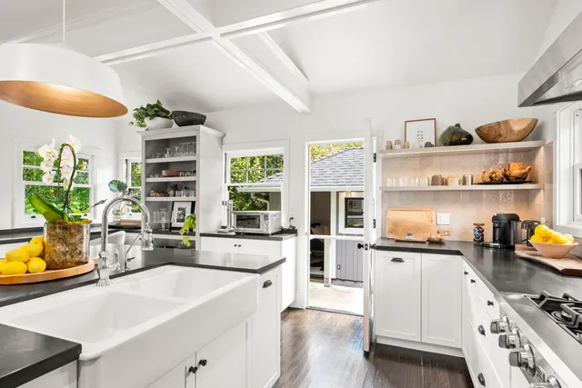 a kitchen with a sink a stove and cabinets