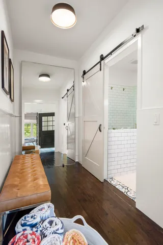 a view of a house with swimming pool and lawn chairs under an umbrella