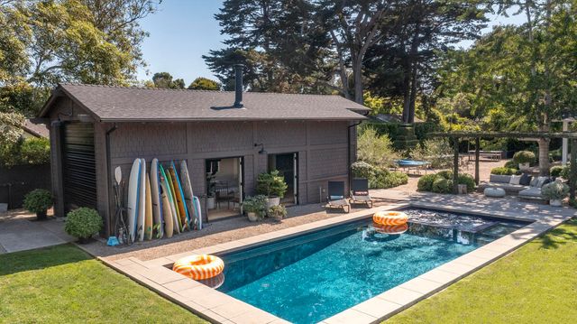 a view of a house with swimming pool and sitting area