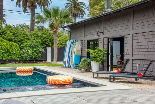 a view of a house with swimming pool and sitting area