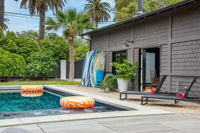 a view of a house with swimming pool and sitting area