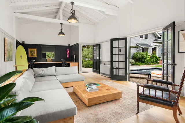 an aerial view of a house with swimming pool and lounge chairs