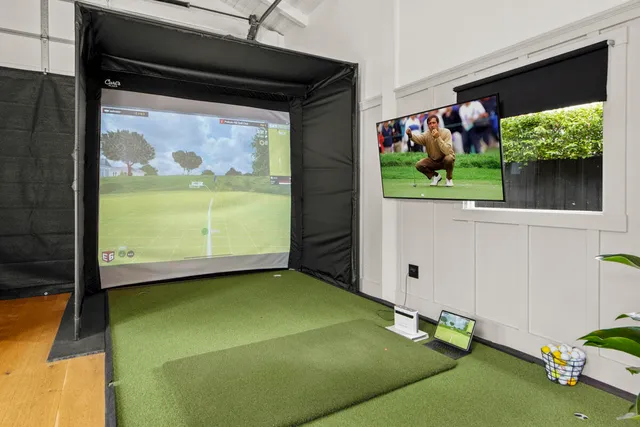 a view of house in front of a big yard with large trees
