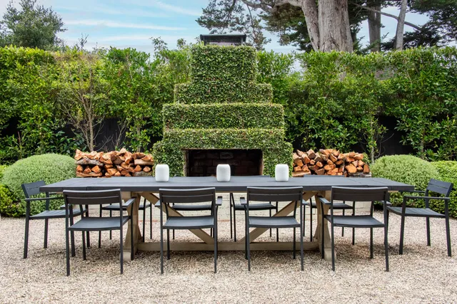 a front view of a house with a yard and potted plants