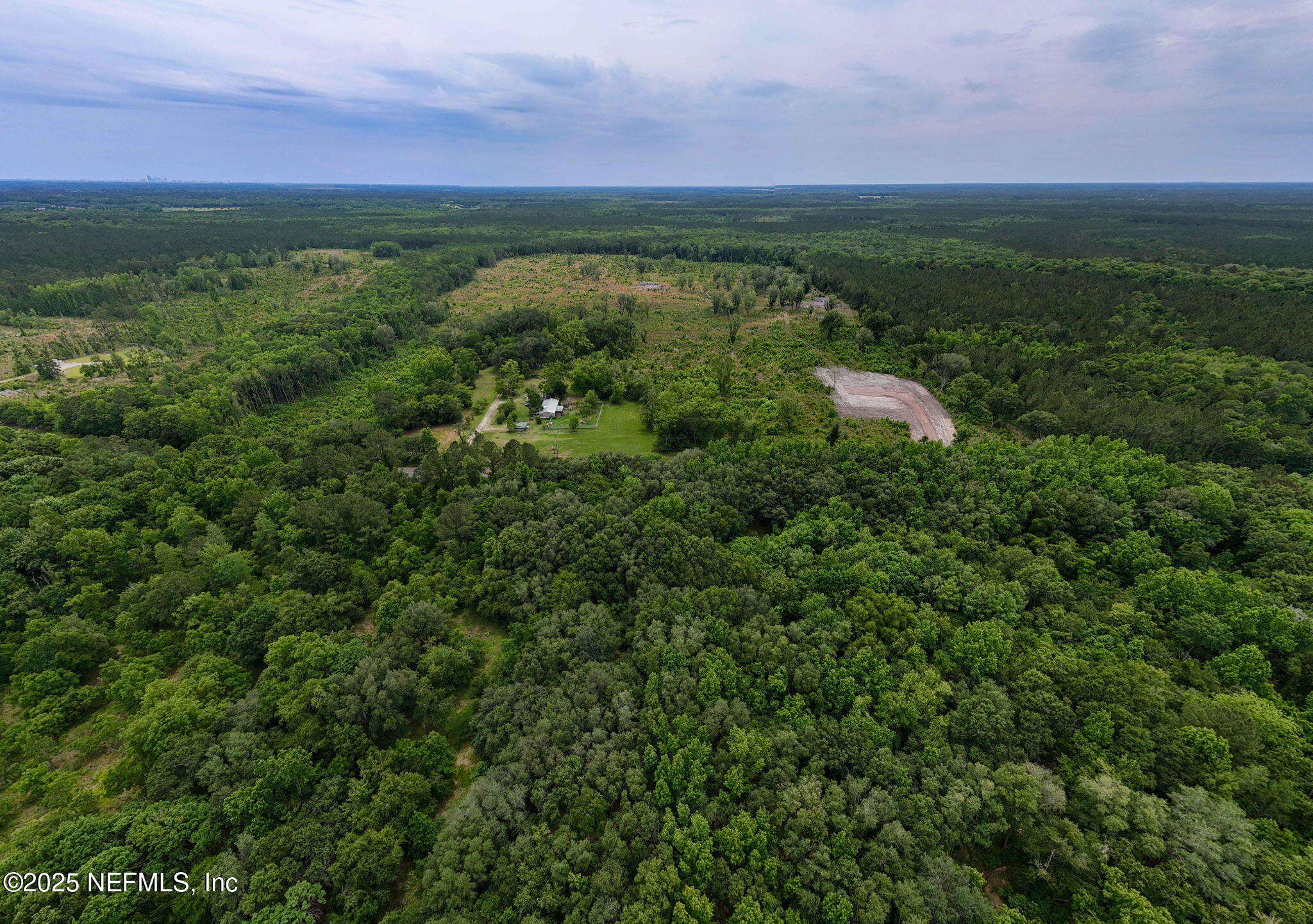 8549 Thomas Road Jacksonville, FL 32219 - Photo 2 of 30 a view of a city with lush green forest
