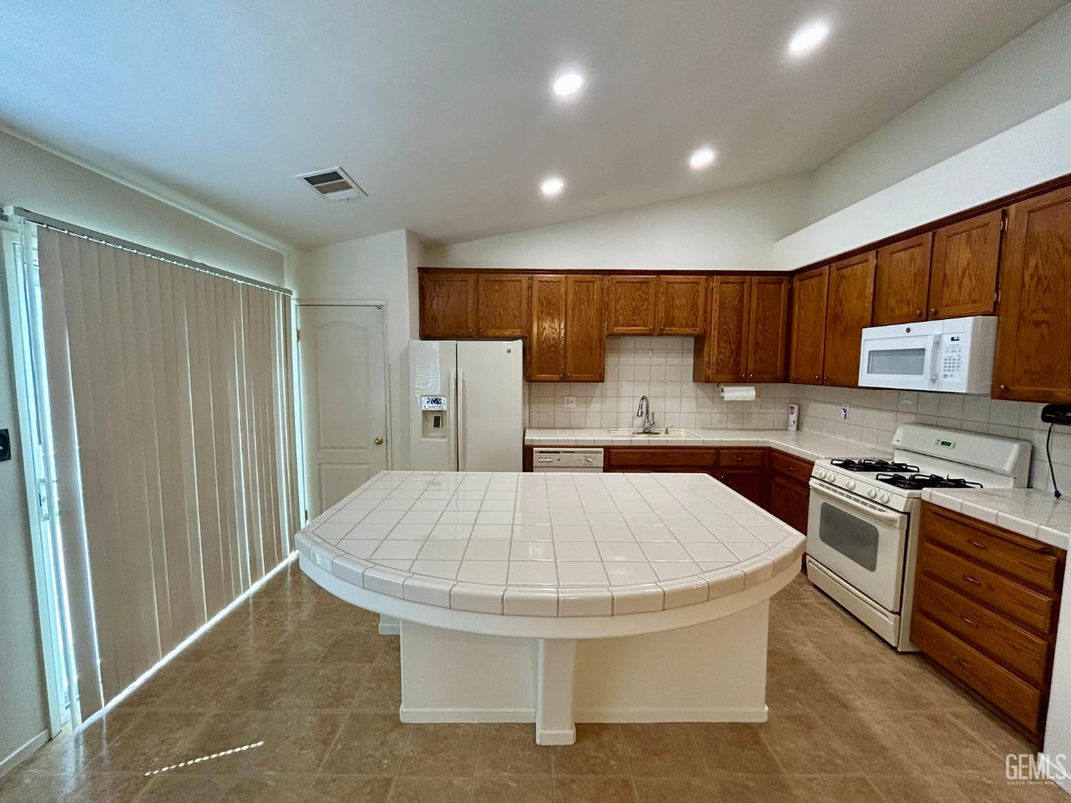 Undisclosed Address Bakersfield, CA 93311 - Photo 5 of 16 a kitchen with stainless steel appliances granite countertop a refrigerator stove microwave and sink