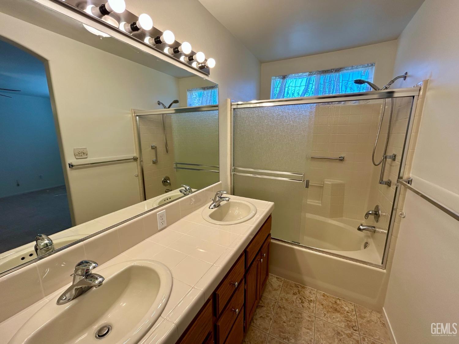 Undisclosed Address Bakersfield, CA 93311 - Photo 9 of 16 a bathroom with a sink and mirror