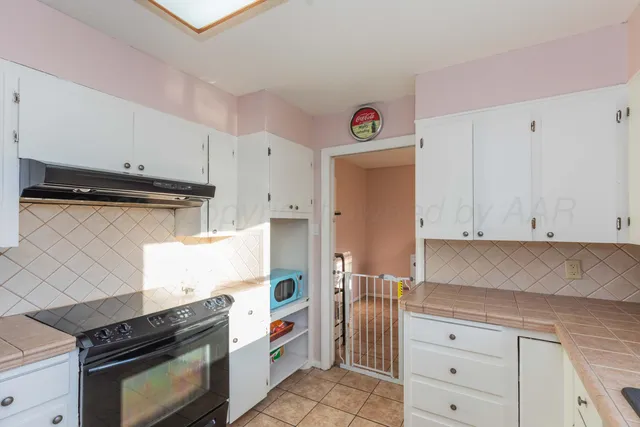 a kitchen with granite countertop a stove and a cabinets