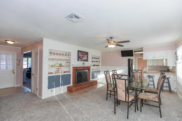 a view of a livingroom with furniture and fireplace