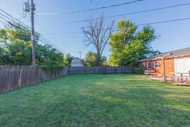 a view of a backyard with sitting area