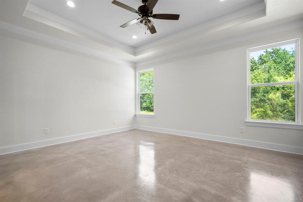 484 Clark Lake Road Weatherford, TX 76088 - Photo 12 of 21 en empty room with windows and ceiling fan