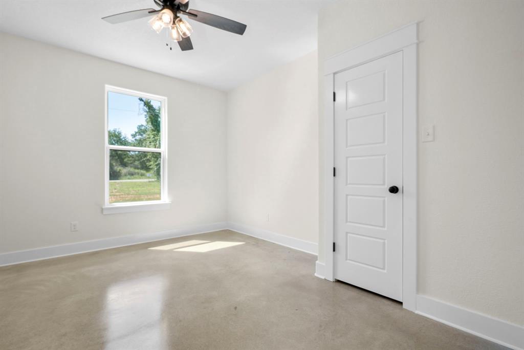 484 Clark Lake Road Weatherford, TX 76088 - Photo 18 of 21 an empty room with windows and fan