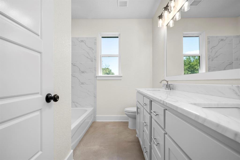 484 Clark Lake Road Weatherford, TX 76088 - Photo 20 of 21 a bathroom with a granite countertop sink a toilet and shower