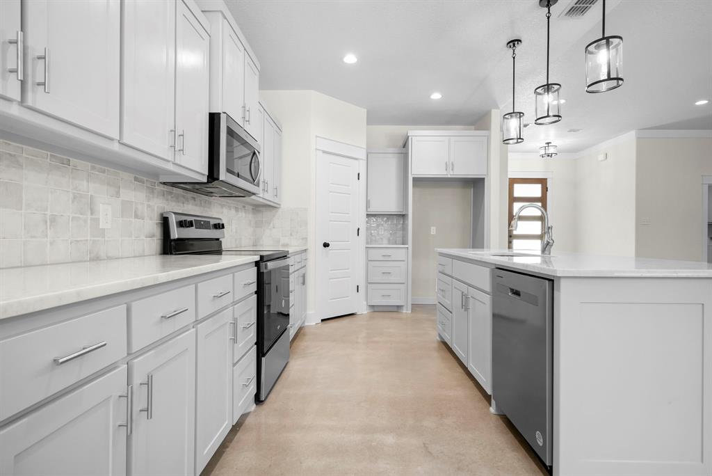 484 Clark Lake Road Weatherford, TX 76088 - Photo 9 of 21 a kitchen with white cabinets and window