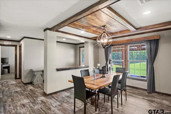 a view of a dining room with furniture wooden floor and chandelier