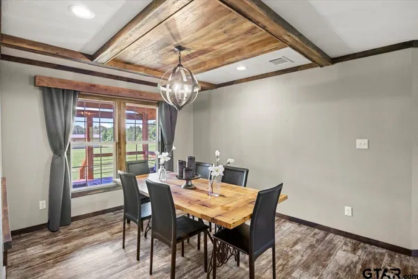 a kitchen with stainless steel appliances granite countertop a stove top oven a refrigerator a sink and a center island