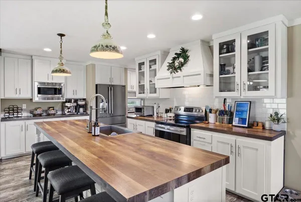 a living room with furniture kitchen view and a table