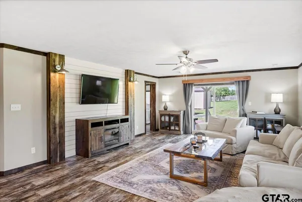 a spacious bedroom with a bed and a flat screen tv