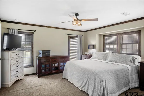 a spacious bathroom with a tub sink and mirror