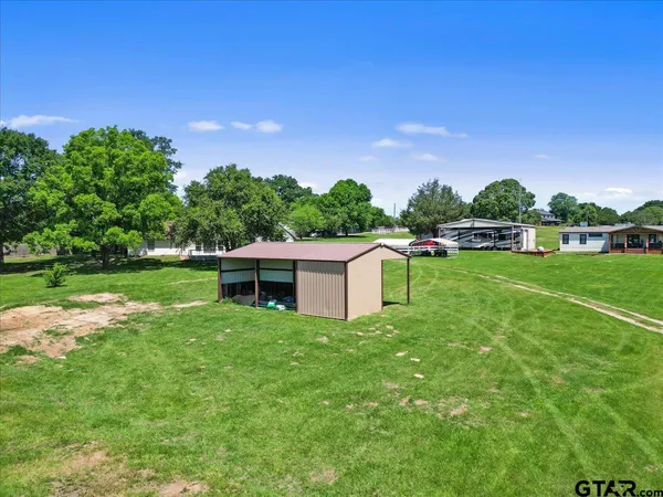 a view of a backyard with a tree