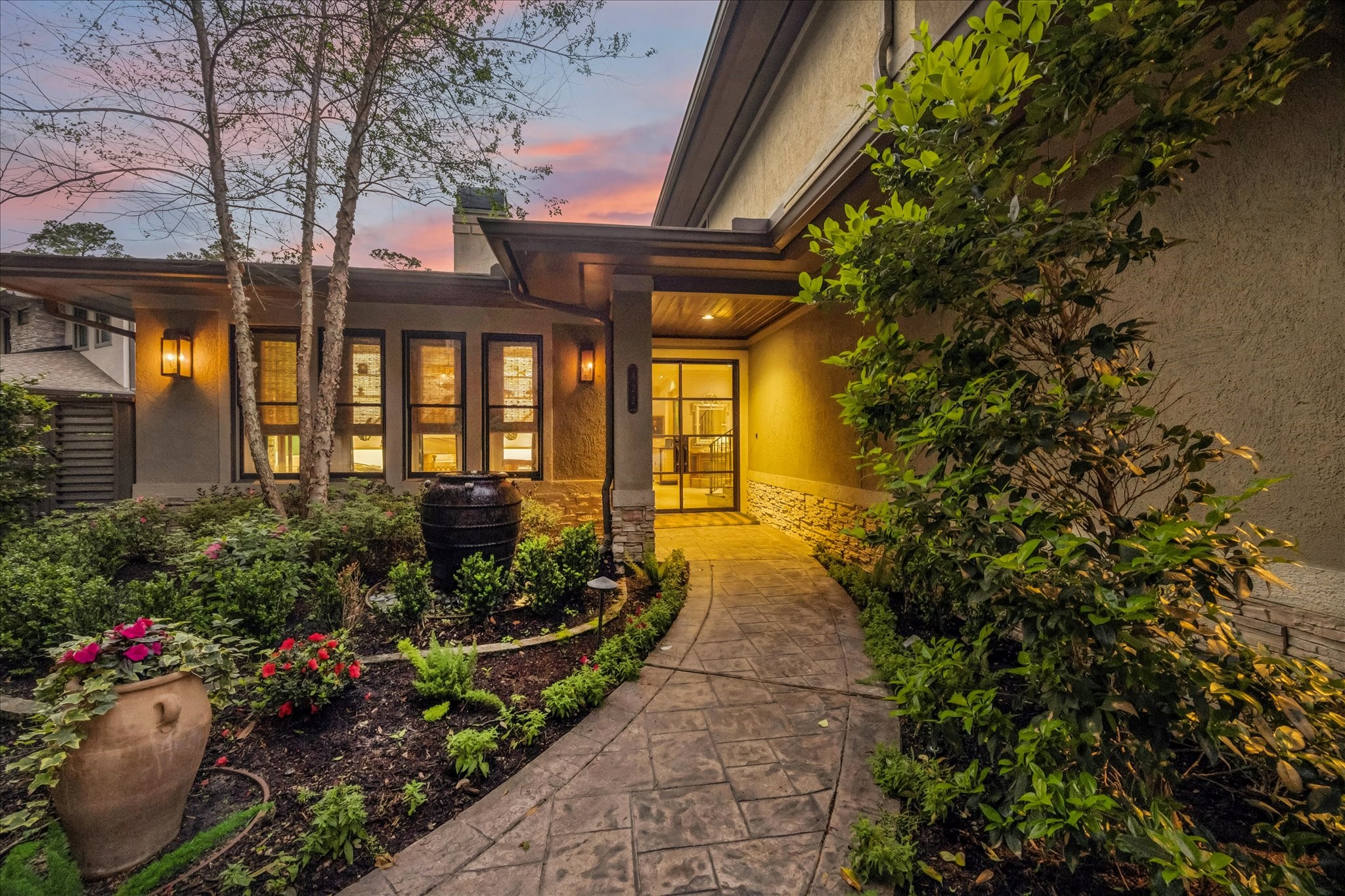 422 Pinewold Drive Houston, TX 77056 - Photo 1 of 49 This sophisticated home entrance with a paved walkway, lush landscaping, and covered pathway. The exterior features large windows and elegant stone accents, offering a welcoming and tranquil ambiance.