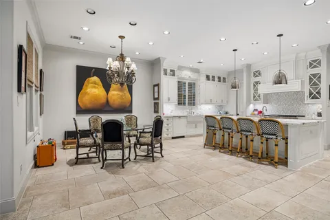 a kitchen that has a lot of cabinets in it and appliances
