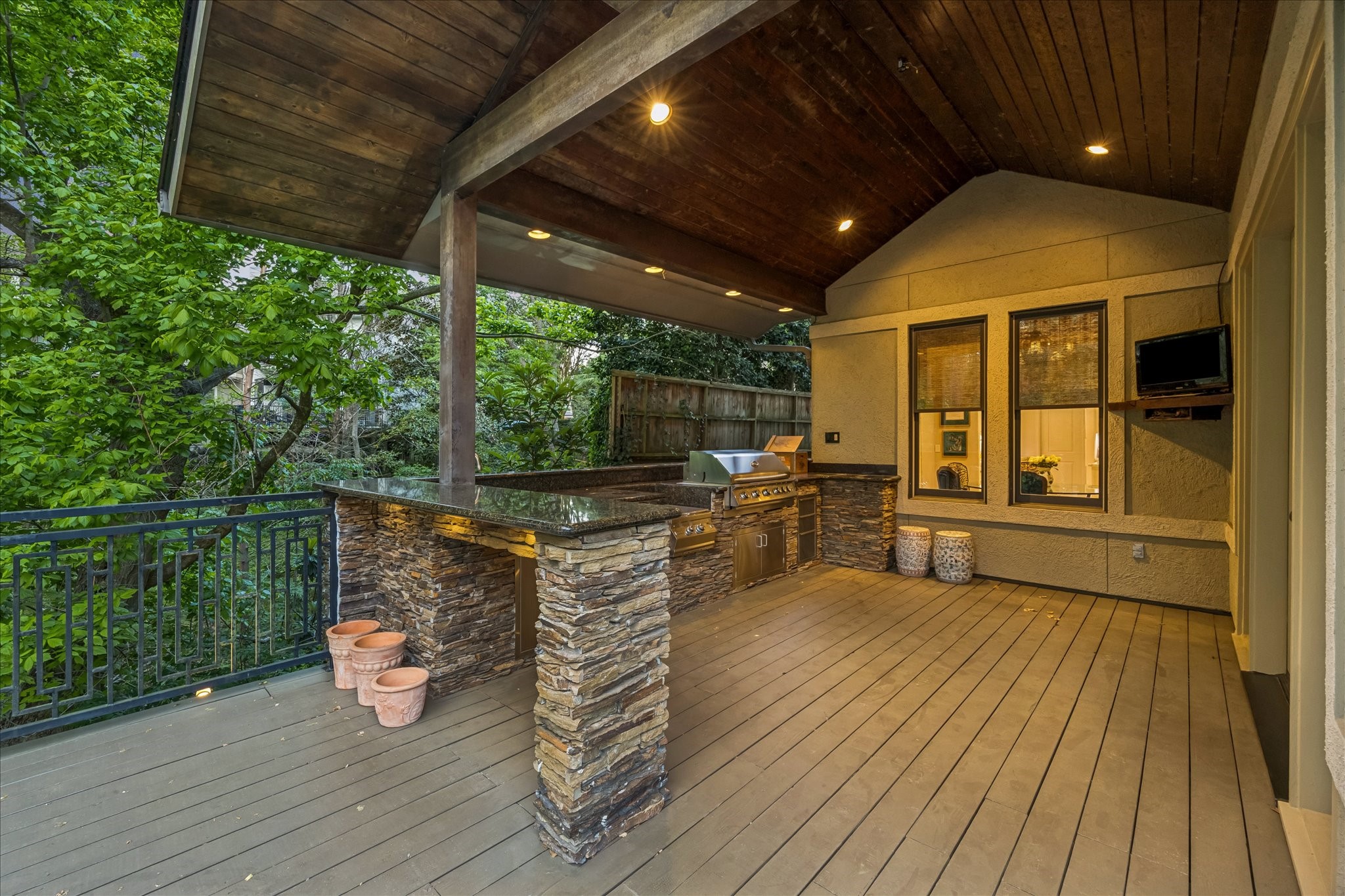 422 Pinewold Drive Houston, TX 77056 - Photo 39 of 49 a view of a patio with table and chairs a barbeque with wooden floor and fence