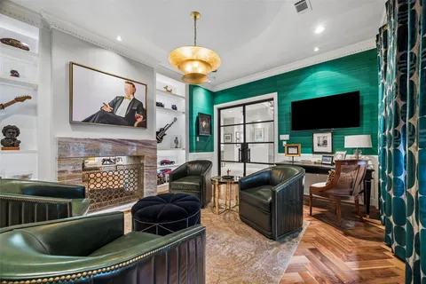 a living room with furniture fireplace and a large window