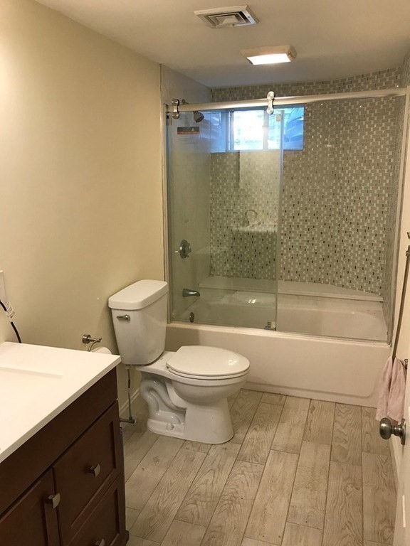 65 Conwell Avenue, Unit 1 Somerville, MA 02144 - Photo 12 of 16 a bathroom with a toilet a sink and shower
