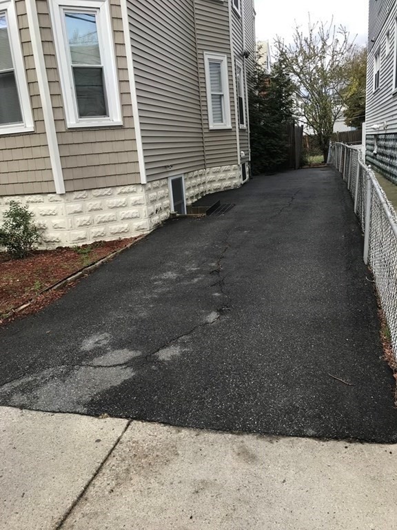 65 Conwell Avenue, Unit 1 Somerville, MA 02144 - Photo 16 of 16 a view of a house with a yard