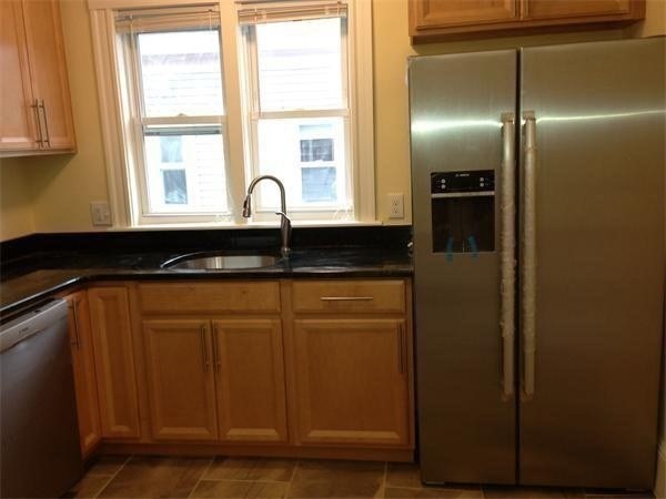 65 Conwell Avenue, Unit 1 Somerville, MA 02144 - Photo 3 of 16 a kitchen with a refrigerator and a sink