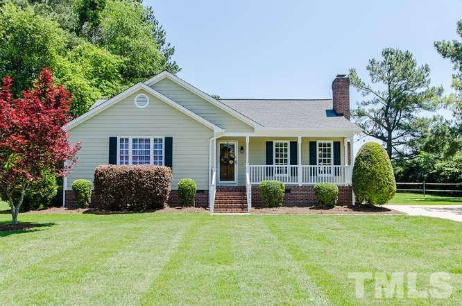 1912 Old Greenfield Road Raleigh, NC 27604 - Photo 1 of 25 a front view of a house with a yard and potted plants