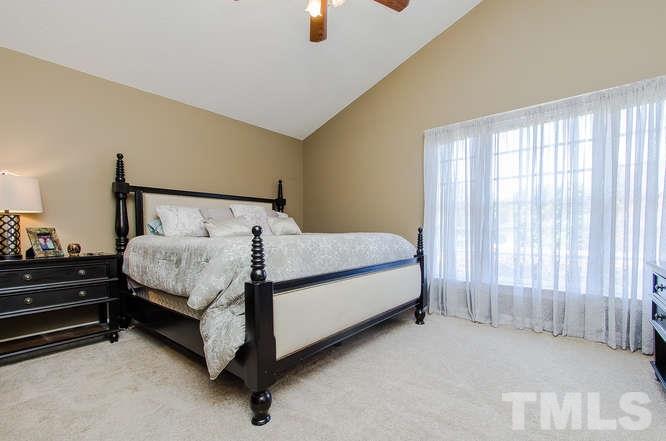 1912 Old Greenfield Road Raleigh, NC 27604 - Photo 12 of 25 a bed sitting in a bedroom next to a window
