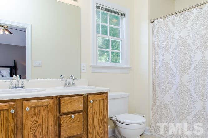 1912 Old Greenfield Road Raleigh, NC 27604 - Photo 17 of 25 a bathroom with a granite countertop sink toilet and a mirror