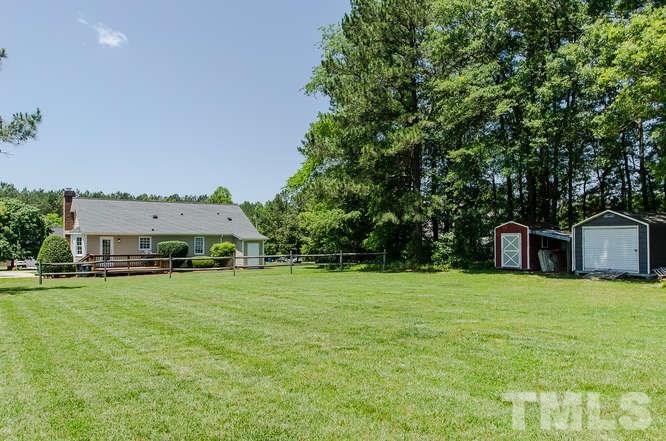 1912 Old Greenfield Road Raleigh, NC 27604 - Photo 21 of 25 a view of a house with a yard and garage
