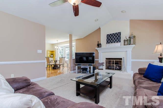 1912 Old Greenfield Road Raleigh, NC 27604 - Photo 4 of 25 a living room with furniture a fireplace and a flat screen tv