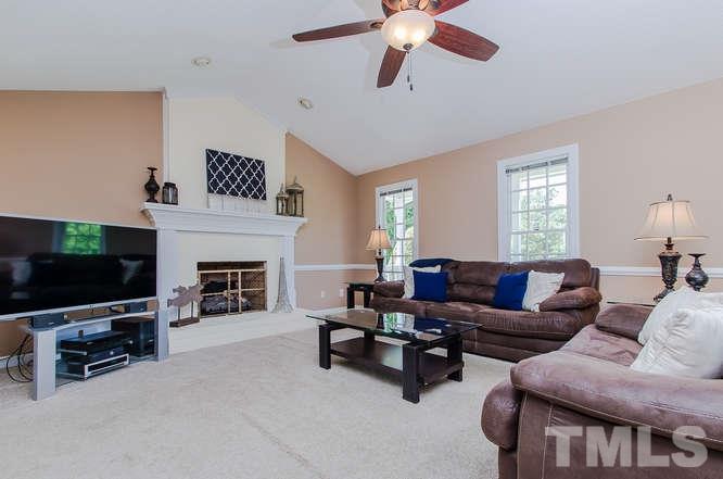 1912 Old Greenfield Road Raleigh, NC 27604 - Photo 5 of 25 a living room with furniture a flat screen tv and a fireplace