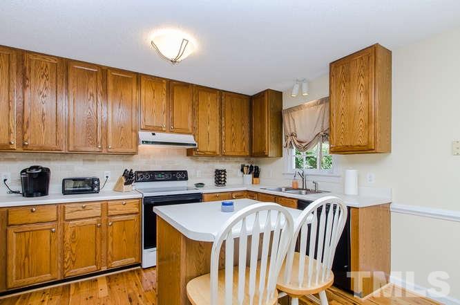 1912 Old Greenfield Road Raleigh, NC 27604 - Photo 10 of 25 a kitchen with stainless steel appliances granite countertop a stove a sink dishwasher and cabinets with wooden floor