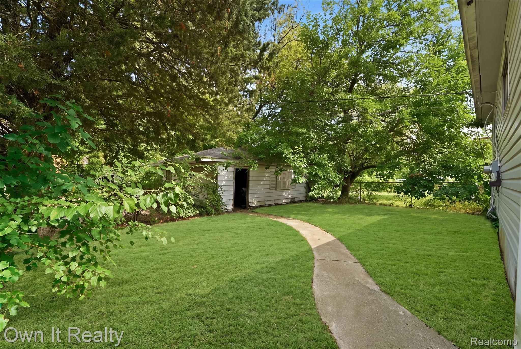 26772 Colgate Street Inkster, MI 48141 - Photo 22 of 25 Expansive green lawn with a curved concrete pathway leading to a detached structure
