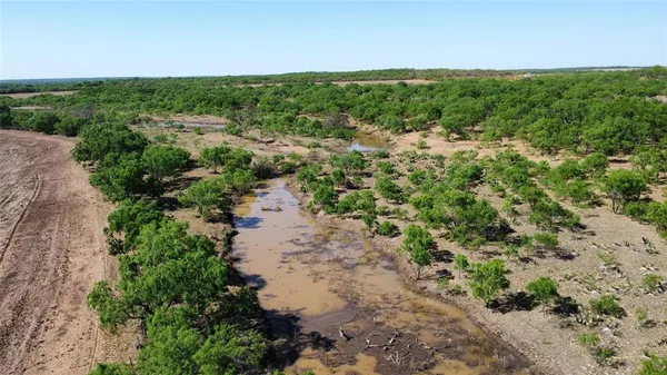 an aerial view of a houses with outdoor space and trees