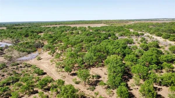 an aerial view of a beach with a yard