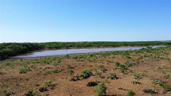 a view of a lake with beach and city view