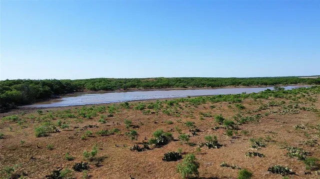 a view of a lake with beach and city view