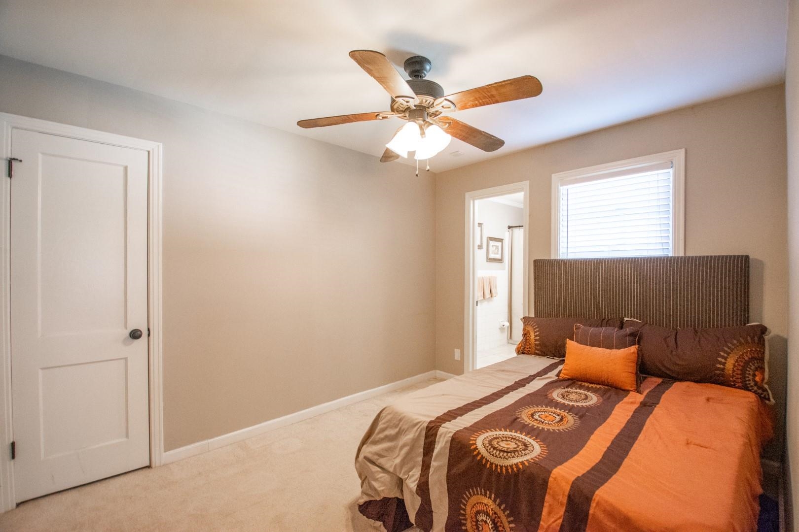 5006 New Castle Road Memphis, TN 38117 - Photo 15 of 20 a bedroom with a bed and a chandelier
