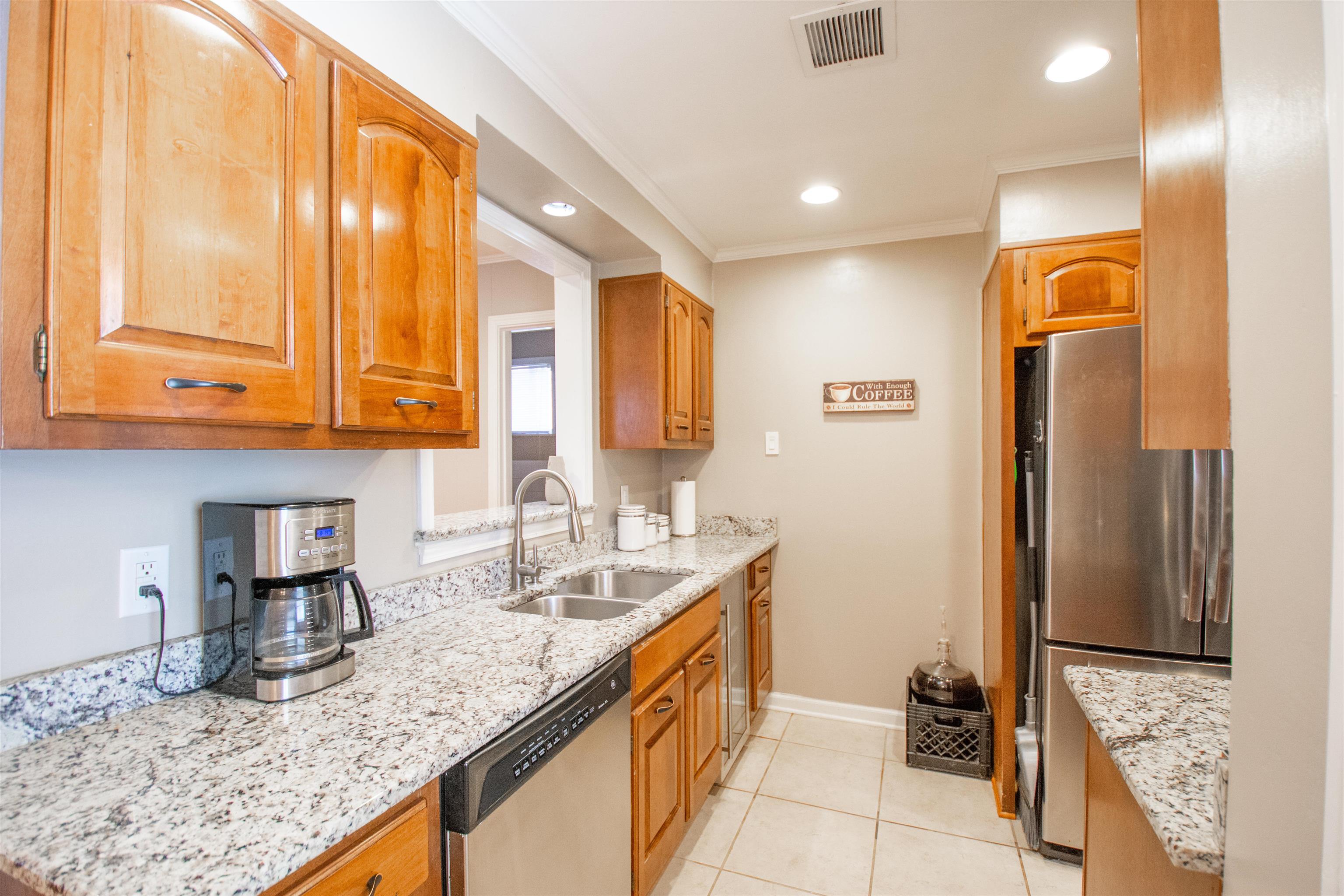 5006 New Castle Road Memphis, TN 38117 - Photo 3 of 20 a kitchen with stainless steel appliances granite countertop a sink and a refrigerator