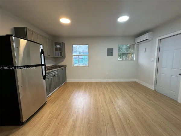 a kitchen with a stove refrigerator and microwave